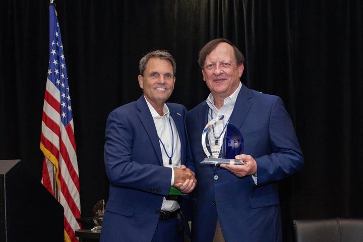 Cox Family Office CEO Sandy Schwartz (R) accepts his award from IARA President Paul Seger. - Photo: IARA